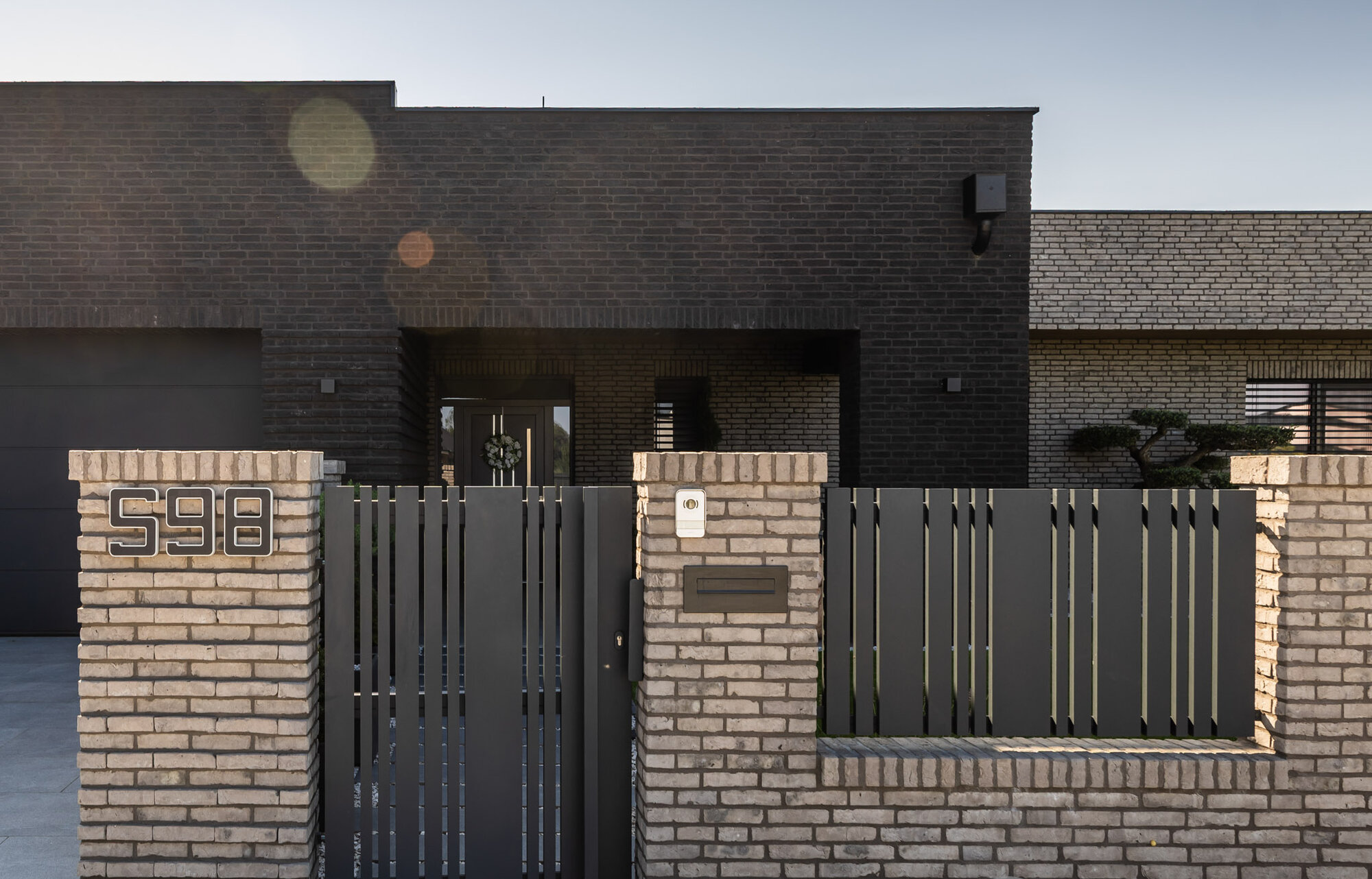 Kombinácia tehlových obkladov Akita a Zwart Super na fasáde a plote rodinného domu od Rustique.sk